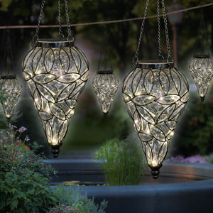 Solar Tear Shaped Clear Glass and Metal Hanging Lantern with 15 Warm White LED Fairy Firefly String Lights, 7 by 24 Inches | Exhart